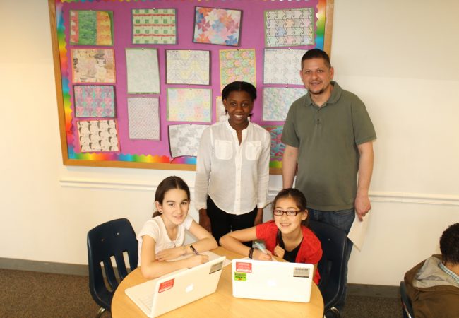 math teacher and students using computers